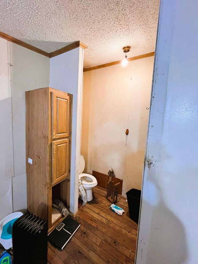 Bathroom featuring hardwood / wood-style floors, crown molding, toilet, and a textured ceiling | Image 14