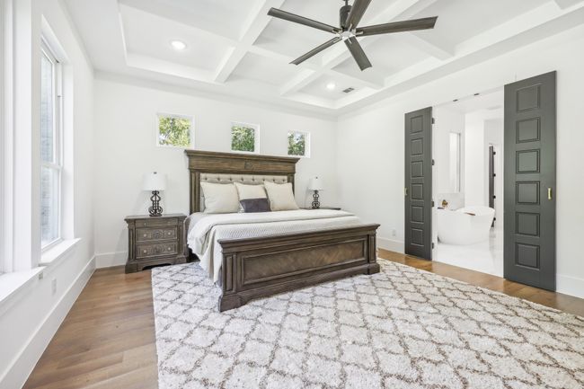 Bedroom with coffered ceiling, wood finished floors, beamed ceiling, recessed lighting, and ceiling fan | Image 15