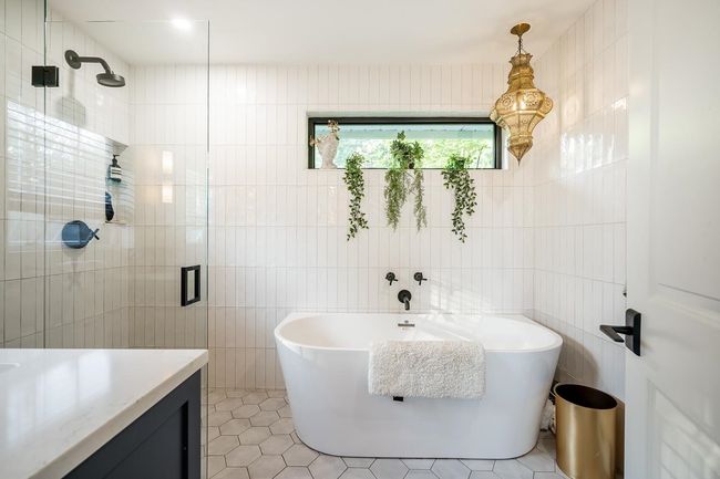 Full bath with tile walls, a shower stall, a freestanding tub, tile patterned flooring, and vanity | Image 14