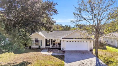 Single story home featuring a front lawn, a porch, and a garage | Image 2