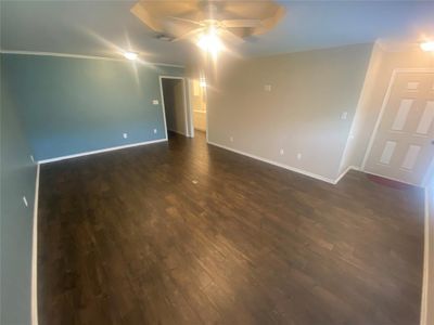 Front Living Room featuring crown molding, ceiling fan, and dark hardwood / wood-style floors | Image 3