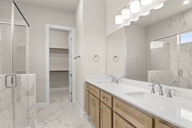 Full bathroom with marble finish flooring, a marble finish shower, double vanity, baseboards, and a spacious closet | Image 27