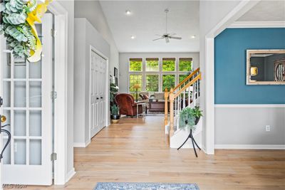 Entryway with ceiling fan, light hardwood / wood-style flooring, and vaulted ceiling | Image 2