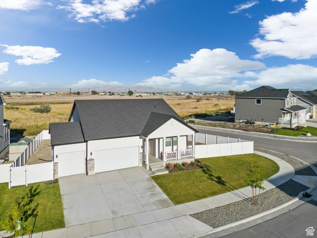 View of front of property featuring a fenced backyard, a porch, concrete driveway, and a front yard | Image 4