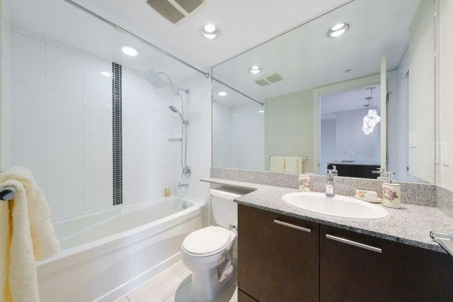 Full bathroom with visible vents, toilet, vanity, and shower / tub combination | Image 16