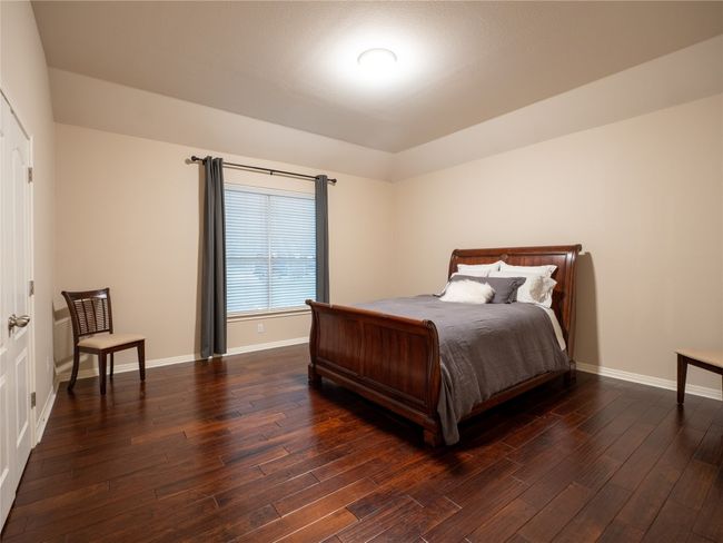 Large bedroom #2 with wood finished floors and baseboards | Image 19