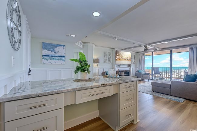 Kitchen featuring built in desk, ceiling fan, light stone countertops, and light hardwood / wood-style flooring | Image 8