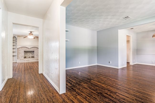 Corridor with dark wood finished floors, baseboards, and built in features | Image 6