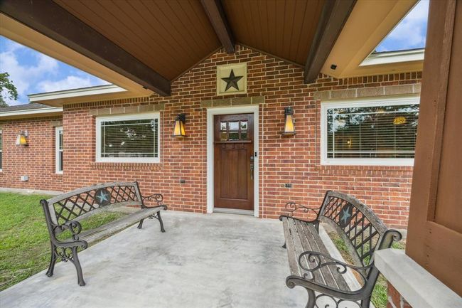 THE CRAFTSMANSHIP STARTS HERE! ENTER THE HOME UNDER THIS AMAZING PORCH THROUGH THE WALNUT STAINED FRONT DOOR. LUXURY WOOD-PANELED OVER HANG PROVIDES A WELCOMING TOUCH AS YOU RELAX ENJOYING THE COUNTRY BREEZE | Image 5