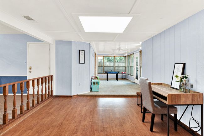 Office area featuring wood finished floors and a skylight | Image 10