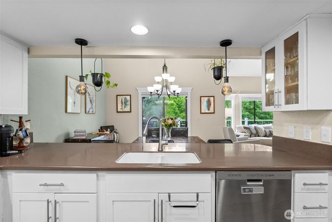 Kitchen looking towards the breakfast bar and dining area that open to the deck | Image 13