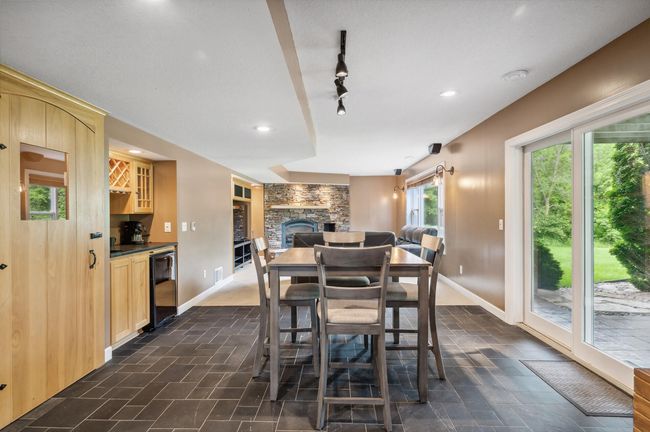 Downstairs entertainment area with wet bar, walkout and under stair wine nook. | Image 28