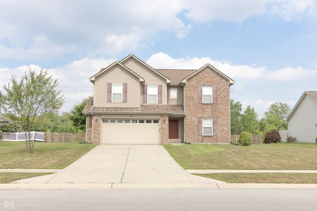 traditional-style home with a garage, brick siding, and concrete driveway | Image 33