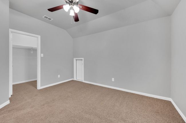 Upstairs bedroom with carpet floors, lofted ceiling, a walk in closet. | Image 26