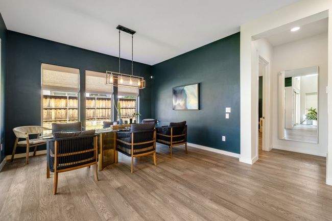 Dining space featuring wood finished floors, a chandelier, and recessed lighting | Image 18