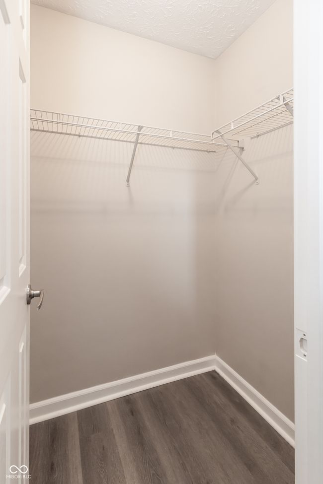 walk in closet with dark wood-type flooring | Image 26
