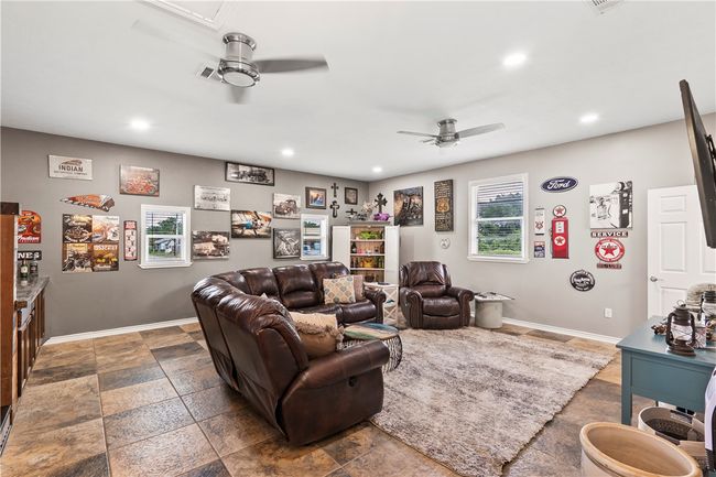Living area featuring a ceiling fan, recessed lighting, and stone tile floors | Image 25