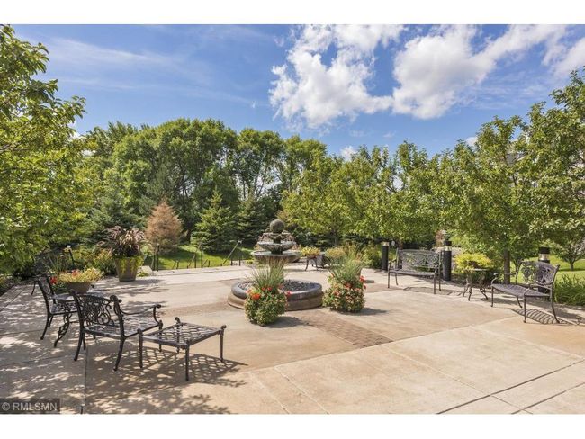 The main patio off the great room is ideal for hosting larger outdoor events, featuring a relaxing water fountain and surrounded by lush greenery with beautiful nature views. | Image 37