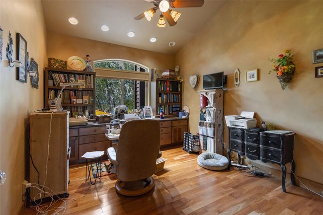 Office area featuring light wood finished floors, a ceiling fan, recessed lighting, and high vaulted ceiling | Image 30