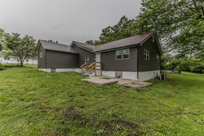 Back of house featuring a lawn, metal roof, and cooling unit | Image 56