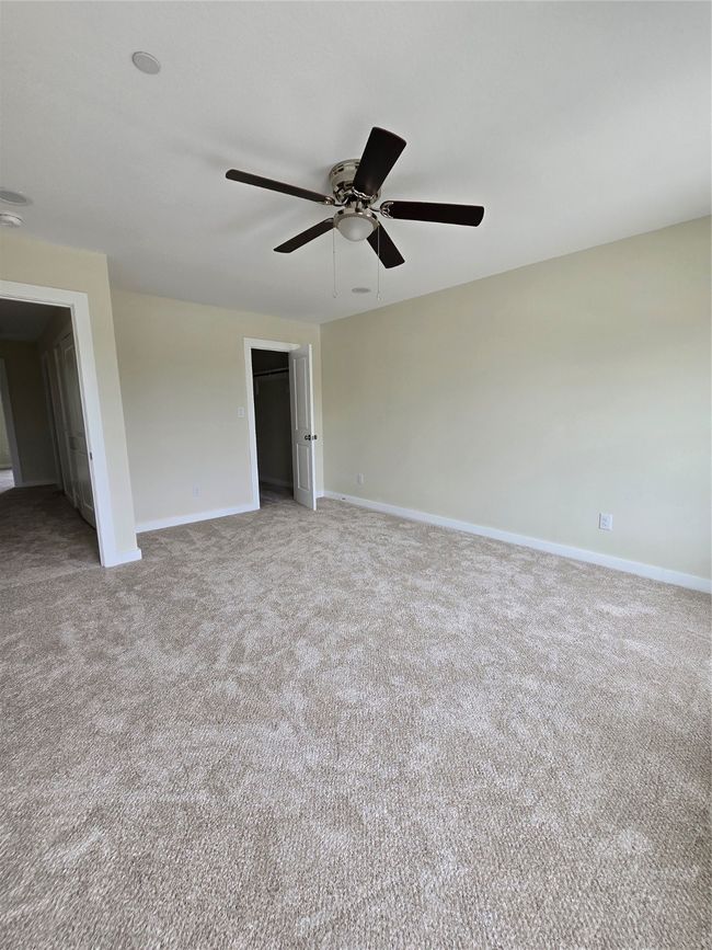 Empty room featuring a ceiling fan, carpet flooring, and baseboards | Image 22