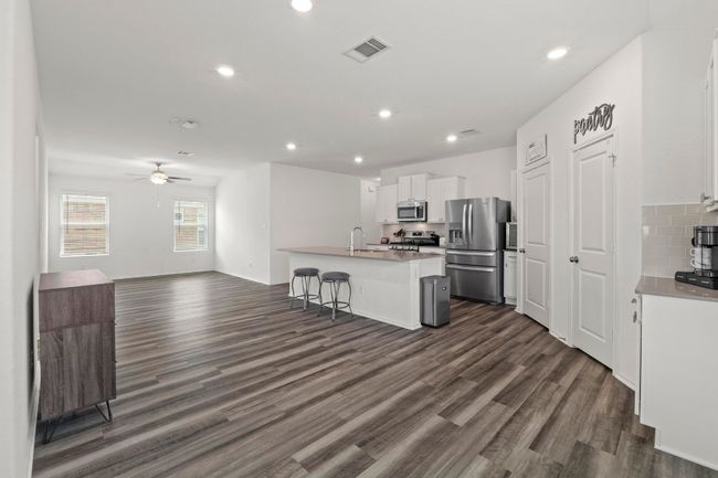 The pantry and laundry room are located off the kitchen. | Image 12