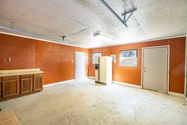 Garage featuring white fridge with ice dispenser | Image 27