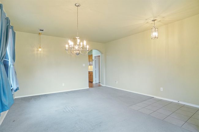 Dining room featuring baseboards, arched walkways, carpet flooring, and an inviting chandelier | Image 5