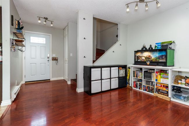 Foyer with stairs, wood finished floors, and a textured ceiling | Image 4