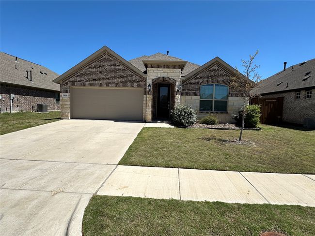 View of front of house with central AC unit, driveway, brick siding, a garage, and a front yard | Image 5