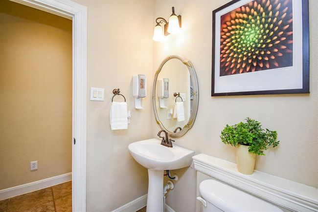 A separate water closet with charming fixtures maintains privacy while complementing the bathroom’s refined aesthetic. | Image 26