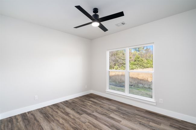 Empty room with wood-type flooring and ceiling fan | Image 9