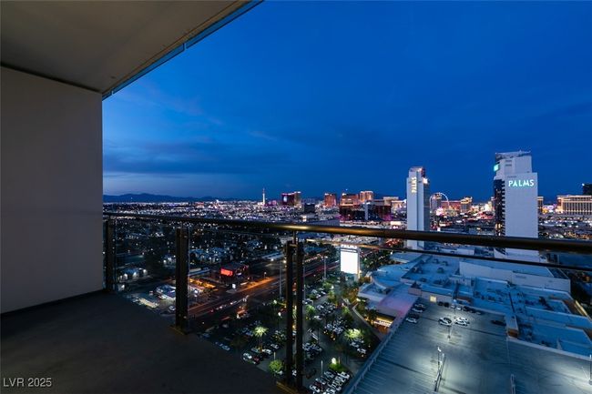 Balcony at night featuring a view of city lights | Image 40