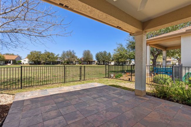 View of patio with a fenced backyard and a residential view | Image 31
