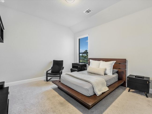 Bedroom featuring light colored carpet and lofted ceiling | Image 26
