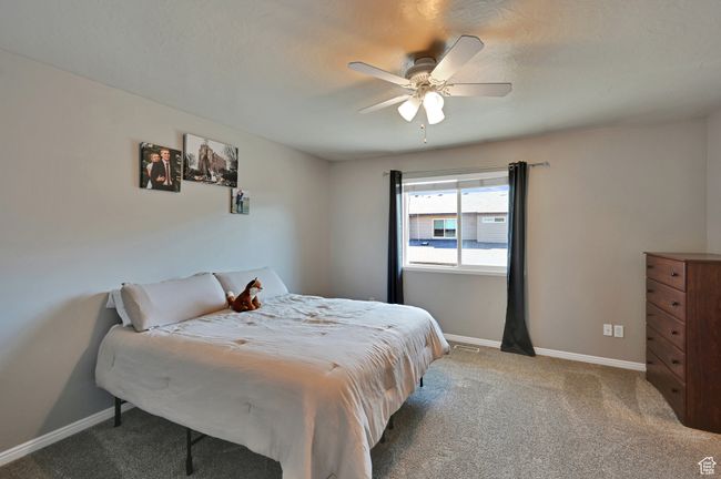 Carpeted bedroom featuring ceiling fan | Image 15