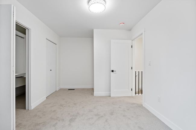 Unfurnished bedroom featuring baseboards and carpet flooring | Image 9