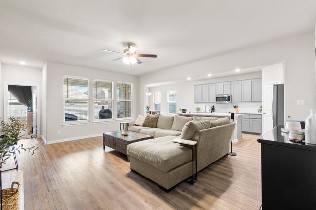 Living room featuring ceiling fan, light wood-style flooring, plenty of natural light, and recessed lighting | Image 5