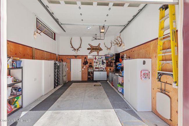 Garage with cabinets, tv and work benches | Image 26