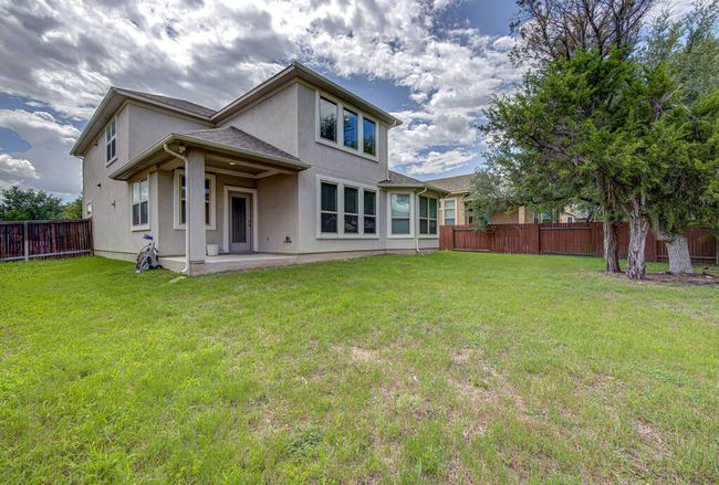 Rear view of house featuring a fenced backyard, a patio area, and stucco siding | Image 27