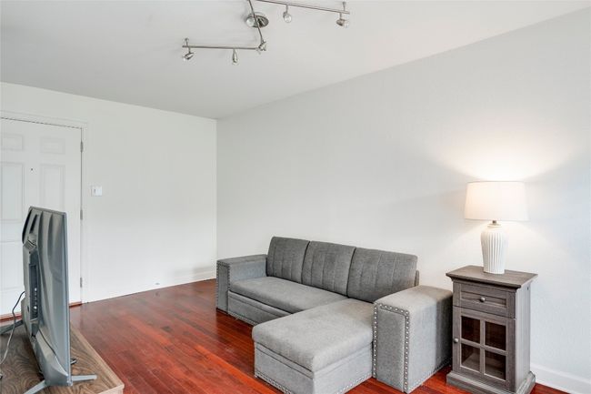Living area with wood finished floors and baseboards | Image 29