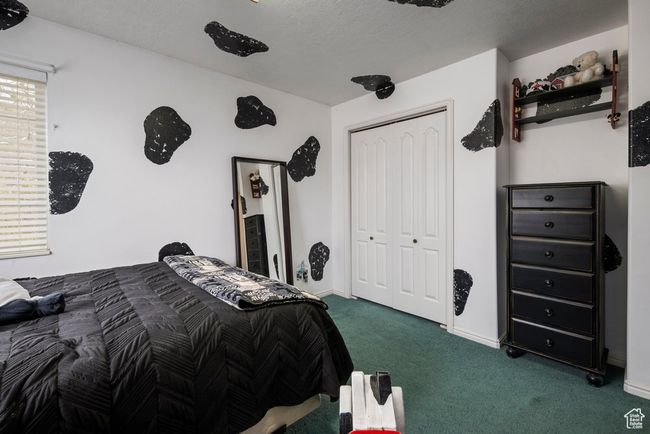Bedroom featuring carpet flooring, baseboards, and a closet | Image 32