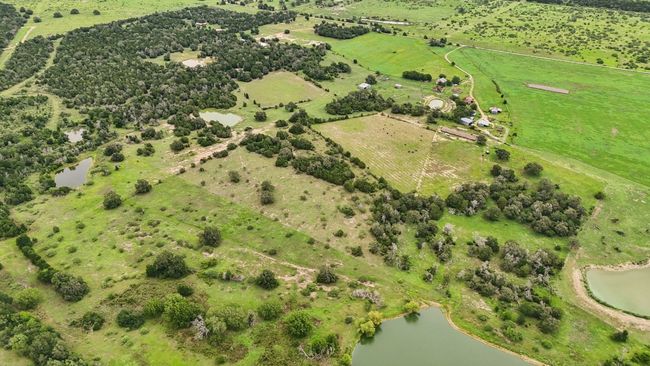 Aerial view of sparsely populated area with a large body of water | Image 20