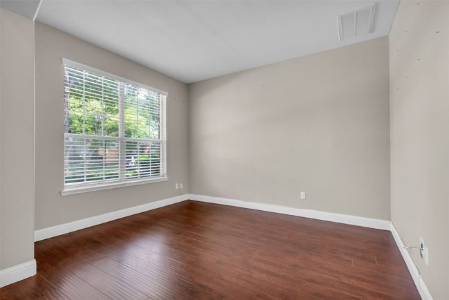 Office with dark wood-style floors. | Image 4