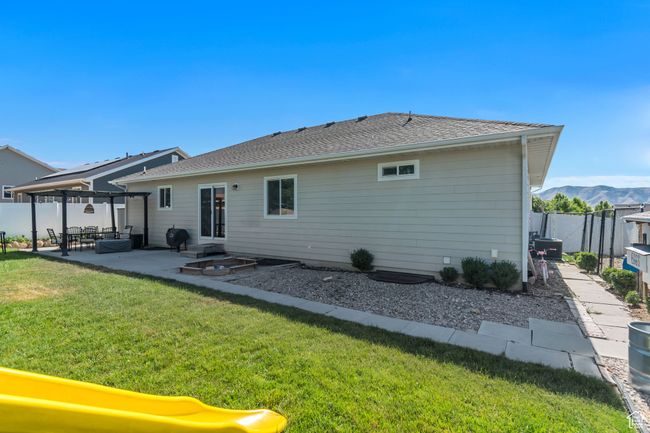 Rear view of property with a patio area, a fenced backyard, and a pergola | Image 31