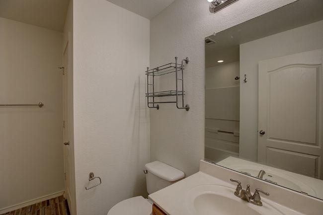 Bathroom featuring vanity, toilet, wood finished floors, and baseboards | Image 32