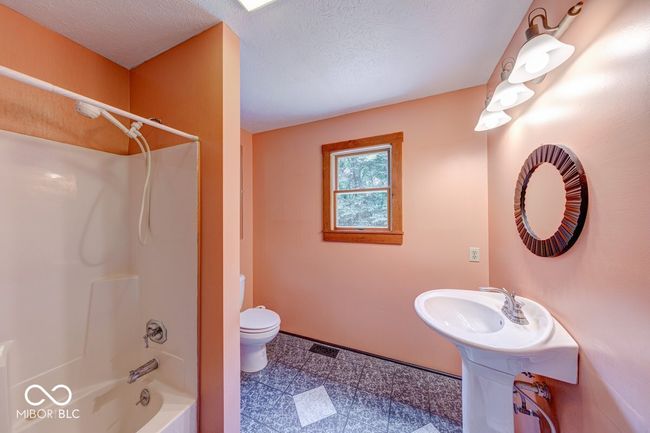 full bath with shower / bath combination and a textured ceiling | Image 37