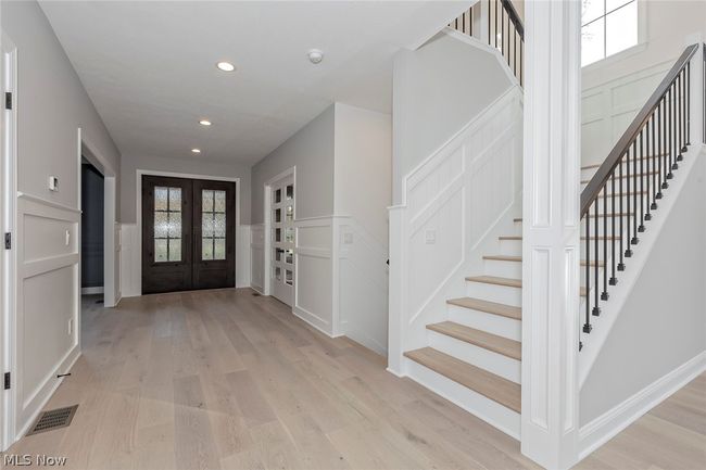 Entryway featuring a healthy amount of sunlight, light hardwood / wood-style floors, and french doors | Image 5