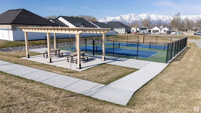 Surrounding community with a mountain view, a lawn, a tennis court, fence, and a residential view | Image 30