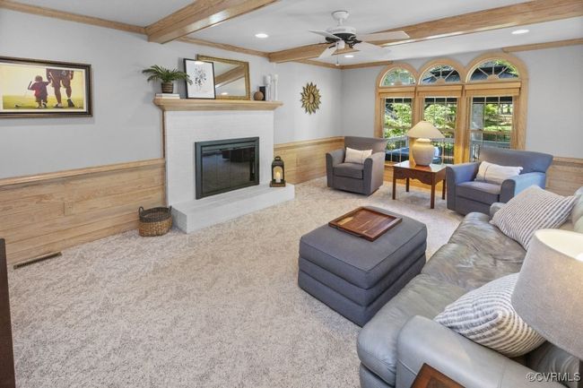 Living room featuring beam ceiling, a fireplace, ceiling fan, carpet floors, and recessed lighting | Image 14